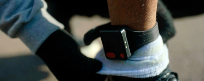 Photo of a GPS ankle tag on someone's leg