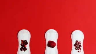 Three period pads with red glitter suggestive of a period stain