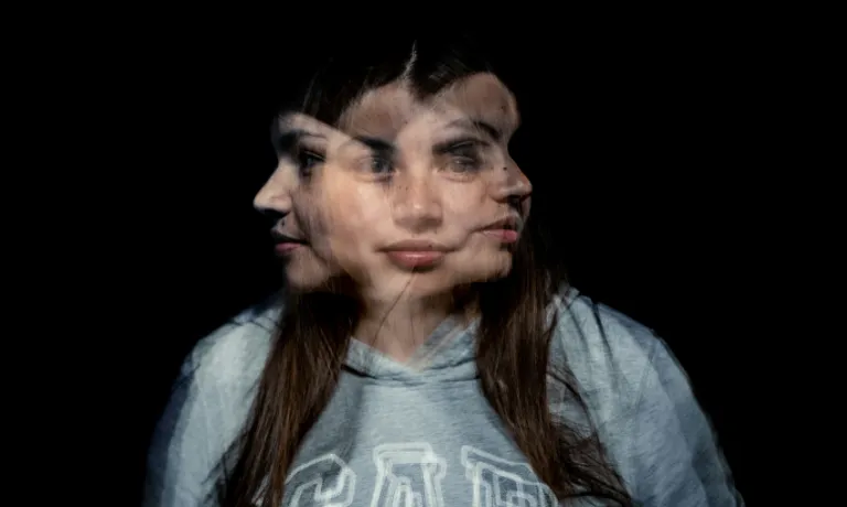 A blurred photo of a woman facing in three directions